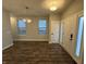 An entryway displays modern lighting and wood-look flooring, leading to a bright living space with ample natural light at 9215 Hawley Dr, Indianapolis, IN 46216