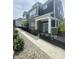 Charming two-story townhome with brick and vinyl siding, black iron fence, sidewalk and landscaped front yard at 9215 Hawley Dr, Indianapolis, IN 46216