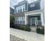 Charming two-story townhome with brick and vinyl siding, black iron fence, sidewalk and front yard at 9215 Hawley Dr, Indianapolis, IN 46216