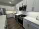 A well-equipped kitchen featuring white cabinets, a subway tile backsplash, and stainless steel appliances, perfect for cooking at 9215 Hawley Dr, Indianapolis, IN 46216