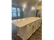 An open kitchen showcases a quartz countertop island with white cabinets, complemented by stainless steel appliances at 9215 Hawley Dr, Indianapolis, IN 46216