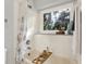 Bright bathroom featuring tiled walls, a soaking tub with natural light, and stylish fixtures at 9578 Cadbury Cir, Indianapolis, IN 46260