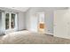 Spacious bedroom with plush carpeting, large window, and a doorway leading to the ensuite bathroom at 9578 Cadbury Cir, Indianapolis, IN 46260