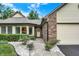 Charming exterior featuring brick, siding, manicured landscaping, and an attached garage at 9578 Cadbury Cir, Indianapolis, IN 46260