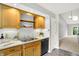 Spacious kitchen showcasing wooden cabinetry, stainless steel sink, and modern appliances at 9578 Cadbury Cir, Indianapolis, IN 46260