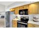 Well-lit kitchen features stainless steel appliances, wooden cabinets, and an adjacent breakfast area at 9578 Cadbury Cir, Indianapolis, IN 46260