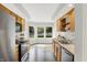 Bright kitchen features wooden cabinets, stainless steel appliances and a sunny view through bay window at 9578 Cadbury Cir, Indianapolis, IN 46260