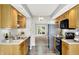 Kitchen with stainless steel appliances, wooden cabinets, and neutral countertops at 9578 Cadbury Cir, Indianapolis, IN 46260