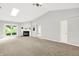 Bright living room with a fireplace, a skylight, and sliding glass doors to the backyard at 9578 Cadbury Cir, Indianapolis, IN 46260