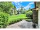 Landscaped patio overlooking grassy area, lined with manicured bushes and greenery at 9578 Cadbury Cir, Indianapolis, IN 46260