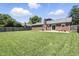 Spacious backyard with a well-manicured lawn, mature trees, and a cozy patio area for outdoor relaxation at 1011 Stevedon Ct, Plainfield, IN 46168