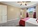 Well-lit bedroom with carpeted floors, a ceiling fan, and a view to the outside yard at 1011 Stevedon Ct, Plainfield, IN 46168