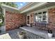 Inviting covered porch with a swing and beautiful brick accents at 1011 Stevedon Ct, Plainfield, IN 46168