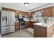 Functional kitchen featuring stainless steel appliances and wooden cabinetry at 1011 Stevedon Ct, Plainfield, IN 46168