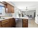 Open concept kitchen with stainless steel dishwasher and views into the adjacent living area at 1011 Stevedon Ct, Plainfield, IN 46168