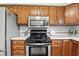 Well-equipped kitchen with stainless steel appliances, including a microwave and a gas range at 1011 Stevedon Ct, Plainfield, IN 46168