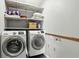 Functional laundry room featuring a modern washer and dryer set and plenty of storage shelves at 1011 Stevedon Ct, Plainfield, IN 46168