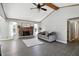 Bright living room featuring a fireplace, ceiling fan, and vaulted ceilings at 1011 Stevedon Ct, Plainfield, IN 46168