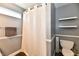 Bathroom featuring a toilet, shower with curtain, shelves, and neutral wall color at 10173 Stillwell Dr, Avon, IN 46123