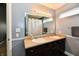 Bathroom featuring a double sink vanity, large mirror, lighting, and neutral wall color at 10173 Stillwell Dr, Avon, IN 46123