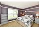 This cozy bedroom boasts a neutral palette, bright window, and ample natural light at 10173 Stillwell Dr, Avon, IN 46123