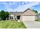 Charming one-story home with a brick facade, well-manicured lawn and a two-car garage at 10173 Stillwell Dr, Avon, IN 46123