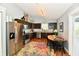 Well-equipped kitchen with stainless steel appliances, dark cabinets, and a charming breakfast nook at 10173 Stillwell Dr, Avon, IN 46123