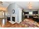 Open-concept kitchen featuring stainless steel appliances, dark wood cabinets, and a cozy dining area at 10173 Stillwell Dr, Avon, IN 46123