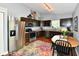 Kitchen with stainless steel appliances, dark cabinets, and adjacent dining area at 10173 Stillwell Dr, Avon, IN 46123