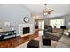Spacious living room with a fireplace, plush seating, and seamless access to the kitchen at 10173 Stillwell Dr, Avon, IN 46123