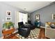 Relaxing corner in living room with comfortable seating, a patterned rug, and decorative wall art at 10173 Stillwell Dr, Avon, IN 46123