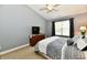 Carpeted main bedroom featuring a TV, ceiling fan, and serene ambiance at 10173 Stillwell Dr, Avon, IN 46123