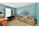 Office space with sofa, featuring a corner desk, chair, and decor in a room with teal walls at 10173 Stillwell Dr, Avon, IN 46123