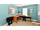 Office space featuring a corner desk, chair, and decor in a room with teal walls at 10173 Stillwell Dr, Avon, IN 46123