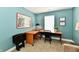 Office space featuring a corner desk, chair, and decor in a room with teal walls at 10173 Stillwell Dr, Avon, IN 46123