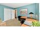 Office space with closet, featuring a corner desk, chair, and decor in a room with teal walls at 10173 Stillwell Dr, Avon, IN 46123