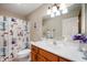 Bright bathroom features a vanity, sink, a decorated shower curtain, and ample lighting at 114 Asbury Dr, Anderson, IN 46013