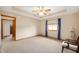 A spacious bedroom shows lots of room, chair by the window and a ceiling fan at 114 Asbury Dr, Anderson, IN 46013