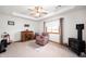 Relaxing bedroom with tray ceiling, ceiling fan, wood burning stove and comfortable seating at 114 Asbury Dr, Anderson, IN 46013