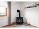 Cozy space features a wood burning stove, small stool and decorative saw on the wall at 114 Asbury Dr, Anderson, IN 46013