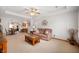 Open-concept living room with a plush sofa, a unique coffee table, and an open flow to dining area at 114 Asbury Dr, Anderson, IN 46013