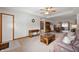 Spacious living room featuring a cozy sofa, stylish decor, and an open layout to the dining area at 114 Asbury Dr, Anderson, IN 46013