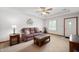 Comfortable living room featuring a plush sofa, stylish coffee table, and a ceiling fan at 114 Asbury Dr, Anderson, IN 46013