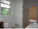 Simple bathroom with a window overlooking a view, shower and sink at , Mooresville, IN 46158