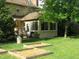 Backyard with a cozy sunroom addition, a lush lawn, and garden boxes filled with mulch at 1327 Goldfinch Dr, Carmel, IN 46032