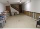 Spacious unfinished basement with stairs, storage bins, and exposed studs, ready for customization at 1327 Goldfinch Dr, Carmel, IN 46032