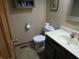 Cozy half bathroom featuring a toilet, sink, and vanity with a cabinet, perfect for guests at 1327 Goldfinch Dr, Carmel, IN 46032