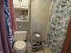 Bathroom with floral wallpaper, toilet, and curtain in the shower at 1327 Goldfinch Dr, Carmel, IN 46032