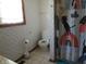 Bathroom with floral wallpaper, toilet, window, and shower curtain at 1327 Goldfinch Dr, Carmel, IN 46032