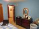 Bedroom with blue walls, a laptop on the bed, and a view to an adjacent room at 1327 Goldfinch Dr, Carmel, IN 46032